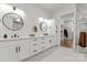 Luxurious bathroom with double vanities, modern fixtures, and a walk-in closet at 621 Poindexter Dr, Charlotte, NC 28209