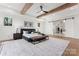 Sunlit primary bedroom with beamed ceilings, decorative lighting, and easy access to an enormous walk-in closet at 621 Poindexter Dr, Charlotte, NC 28209