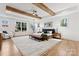 Spacious main bedroom boasts hardwood floors, exposed wood beams, and ample natural light at 621 Poindexter Dr, Charlotte, NC 28209