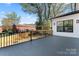 View of the private outdoor space with dark grey patio and fenced in area for gardening at 621 Poindexter Dr, Charlotte, NC 28209