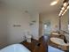 Bright bathroom featuring a double vanity, soaking tub, and shower with modern fixtures and wood-look flooring at 7051 Maple Glen Dr, Catawba, NC 28609