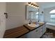 Bright bathroom with double sinks, wood countertop, and a large mirror at 7051 Maple Glen Dr, Catawba, NC 28609