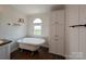 Bathroom featuring a clawfoot tub, storage cabinets, and natural light from an arched window at 7051 Maple Glen Dr, Catawba, NC 28609