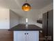 View of the dark countertop kitchen island with pendant lighting at 7051 Maple Glen Dr, Catawba, NC 28609