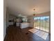 Open-concept kitchen featuring white cabinets, a central island, and wood floors at 7051 Maple Glen Dr, Catawba, NC 28609