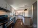 Updated kitchen featuring new stainless steel appliances, white cabinets, and a central island at 7051 Maple Glen Dr, Catawba, NC 28609