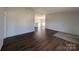 Spacious living room with wood floors, light walls, and an open view to the kitchen at 7051 Maple Glen Dr, Catawba, NC 28609