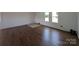 Bright living room with wood-look flooring, white walls, and plenty of natural light at 7051 Maple Glen Dr, Catawba, NC 28609