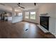 Open-concept living room with fireplace and two large windows at 7051 Maple Glen Dr, Catawba, NC 28609