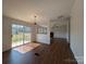 Open living room with sliding glass doors, wood-look floors, and decorative lighting at 7051 Maple Glen Dr, Catawba, NC 28609