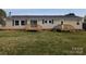 Rear of the home with sliding glass doors, wooden deck and well-kept lawn at 7051 Maple Glen Dr, Catawba, NC 28609