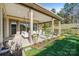 Spacious backyard with a covered patio, including a swing and seating, perfect for outdoor living at 7127 Hanging Rock Ct, Denver, NC 28037