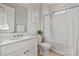 Clean bathroom featuring a single sink vanity, tile flooring, and a shower-tub combo at 7127 Hanging Rock Ct, Denver, NC 28037