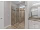 Shower with glass door and neutral tile walls at 7127 Hanging Rock Ct, Denver, NC 28037