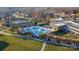 Aerial view of a community pool surrounded by lounge chairs, manicured landscaping, and shade umbrellas at 7127 Hanging Rock Ct, Denver, NC 28037