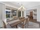 Elegant dining room with a chandelier and sliding doors leading to an outdoor seating area at 7127 Hanging Rock Ct, Denver, NC 28037