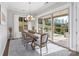 Dining room with a chandelier, a large window, and a sliding door to the outdoor patio at 7127 Hanging Rock Ct, Denver, NC 28037