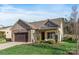 Charming single-Gathering home featuring stone accents, a two-car garage, and a well-maintained lawn at 7127 Hanging Rock Ct, Denver, NC 28037