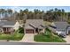 Charming home features a stone-accented facade, well-manicured lawn, and a cozy front porch seating area at 7127 Hanging Rock Ct, Denver, NC 28037