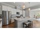 Kitchen with stainless steel appliances, an island with seating, and an open view to the dining area at 7127 Hanging Rock Ct, Denver, NC 28037