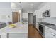 Kitchen with quartz countertops, stainless steel appliances, and an island with a sink and barstool seating at 7127 Hanging Rock Ct, Denver, NC 28037