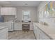 Bright laundry room with built-in cabinets, counter space, and a desk at 7127 Hanging Rock Ct, Denver, NC 28037