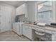 Functional laundry area with washer, dryer, and built-in desk space at 7127 Hanging Rock Ct, Denver, NC 28037