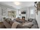 Cozy living room with fireplace, large sofa, and a sliding door to an outdoor patio at 7127 Hanging Rock Ct, Denver, NC 28037