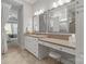 Main bathroom featuring double mirrors, vanity seating, and tiled floors at 7127 Hanging Rock Ct, Denver, NC 28037