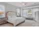 Bright main bedroom with large windows, carpet, and crown molding details at 7127 Hanging Rock Ct, Denver, NC 28037