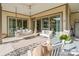 Relaxing covered patio featuring ample seating and a cozy swing, perfect for outdoor enjoyment at 7127 Hanging Rock Ct, Denver, NC 28037