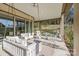 Inviting covered patio with comfortable swing seating, ceiling fan, and serene view of the backyard at 7127 Hanging Rock Ct, Denver, NC 28037