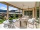 Charming outdoor patio with a table, chairs, swing, and views of the manicured backyard at 7127 Hanging Rock Ct, Denver, NC 28037