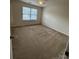 Neutral bedroom featuring plush carpeting, a ceiling fan, and a bright window at 7141 Adare Mews Rd, Charlotte, NC 28217