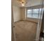 Bedroom features neutral carpet, natural light from a bright window, and a door with hardware at 7141 Adare Mews Rd, Charlotte, NC 28217