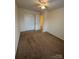 Bedroom with neutral carpet, bi-fold closet, ceiling fan, and a door with natural light at 7141 Adare Mews Rd, Charlotte, NC 28217