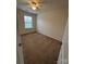 Bedroom features natural lighting from a bright window, ceiling fan, and neutral carpet at 7141 Adare Mews Rd, Charlotte, NC 28217
