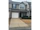 Charming two-story townhouse with a one car garage and well-maintained front lawn at 7141 Adare Mews Rd, Charlotte, NC 28217