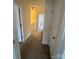 Inviting hallway with neutral tones and access to multiple rooms, creating a seamless flow throughout the home at 7141 Adare Mews Rd, Charlotte, NC 28217