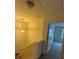 Upstairs hallway boasts a light fixture and an open door to a room with natural lighting at 7141 Adare Mews Rd, Charlotte, NC 28217