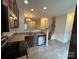 Modern kitchen features stainless steel appliances, granite countertops, and open layout to the living space at 7141 Adare Mews Rd, Charlotte, NC 28217