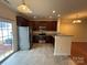 Modern kitchen featuring stainless steel appliances, granite countertops, and tile flooring at 7141 Adare Mews Rd, Charlotte, NC 28217