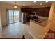 Eat in kitchen featuring stainless steel appliances, granite countertops, tile floors, and slider doors at 7141 Adare Mews Rd, Charlotte, NC 28217