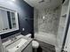 Modern bathroom features a stylish vanity with granite countertop and a bathtub with marble tile surround at 7310 Yorkville Ct, Charlotte, NC 28273