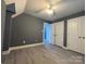 Bedroom featuring a dark gray color scheme, wood floors, and closet doors at 7310 Yorkville Ct, Charlotte, NC 28273