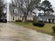 View of house with car in driveway on an overcast day. Well-maintained lawn and landscaping add to curb appeal at 7310 Yorkville Ct, Charlotte, NC 28273