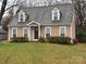 Charming home featuring dormer windows, neutral siding, well-maintained landscaping and a manicured lawn at 7310 Yorkville Ct, Charlotte, NC 28273