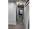 Hallway featuring luxury vinyl plank flooring, new interior paint, and modern lighting fixtures at 7310 Yorkville Ct, Charlotte, NC 28273