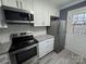 Well-equipped kitchen with stainless steel appliances, granite countertops, and white shaker cabinetry at 7310 Yorkville Ct, Charlotte, NC 28273