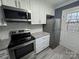 Close up of a kitchen with stainless appliances, granite countertop, and subway tile backsplash at 7310 Yorkville Ct, Charlotte, NC 28273